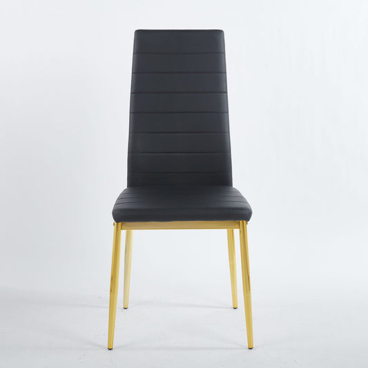 Four modern black faux leather dining chairs with metal frames and gold-accented legs around a table