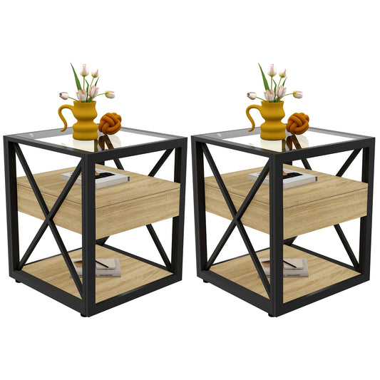 Set of two modern X-frame end tables with glass tops and drawers beside a bed