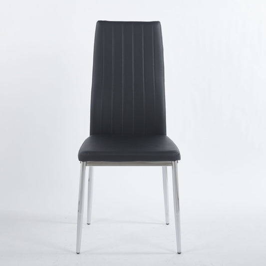 Four minimalist white faux leather dining chairs with metal frames around a modern dining table