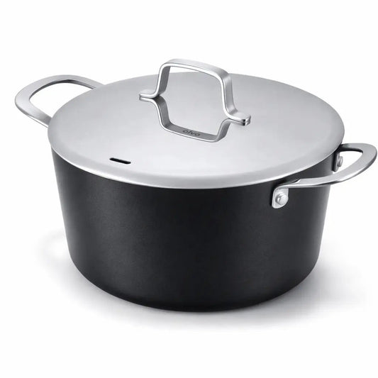 4.5-quart ceramic nonstick stock pot with stainless steel lid and handles on a kitchen stove